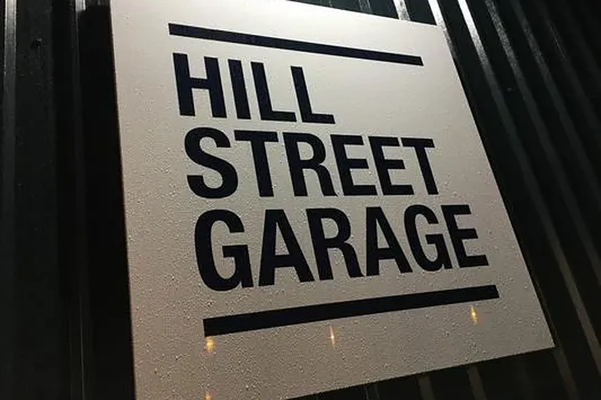 The Hill Street Garage sign on the workshop's cladding